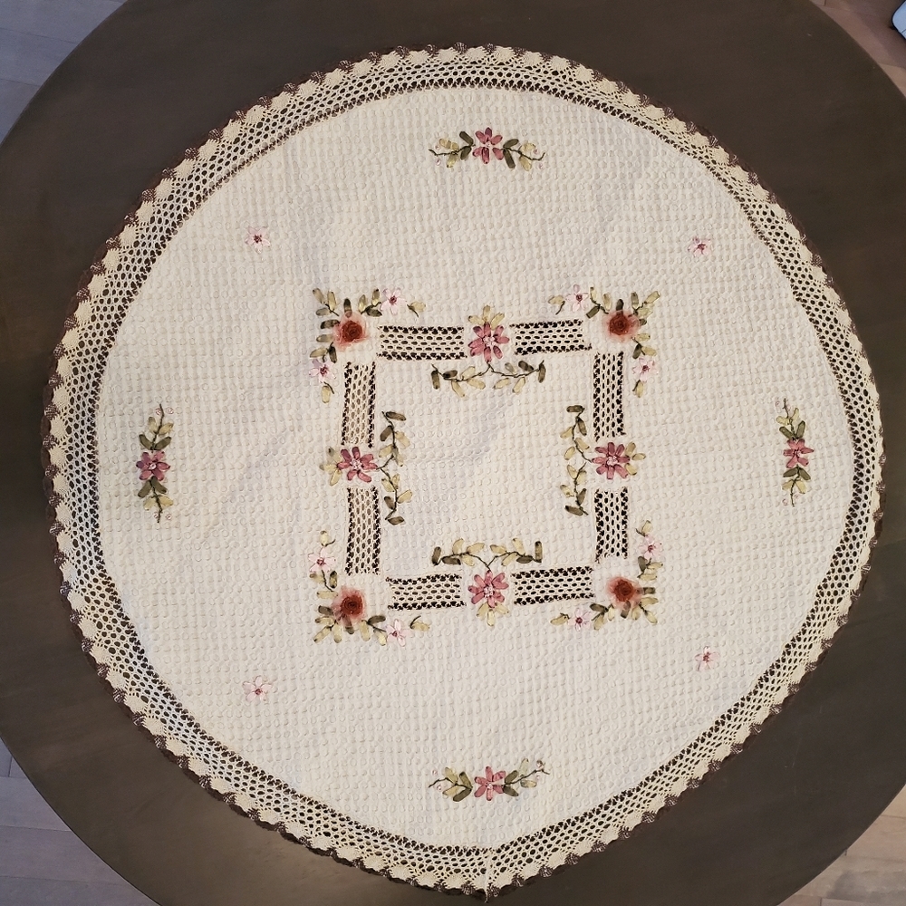 Small vintage round crocheted tablecloth with flowers